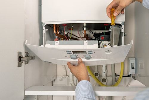 HVAC technician repairing an indoor boiler in Prescott Valley