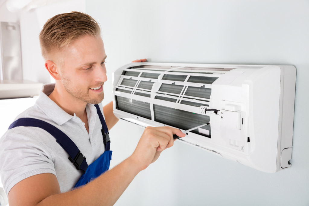 HVAC technician performing ductless air conditioning maintenance in Prescott Valley