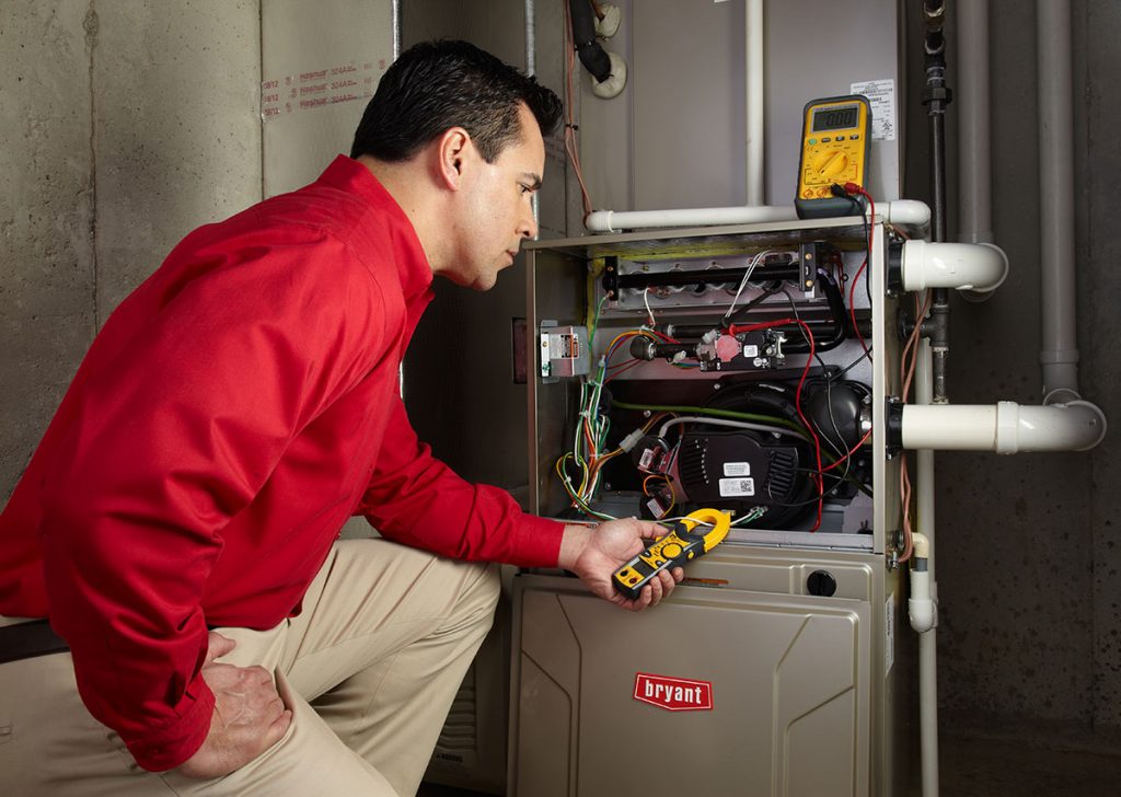 HVAC technician repairing an indoor furnace in Prescott Valley