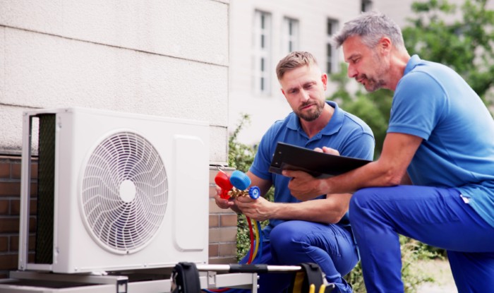 HVAC technicians installing an outdoor air conditioning unit in Prescott Valley