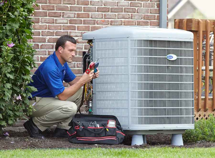 HVAC technician inspecting an outdoor air conditioning unit in Prescott Valley