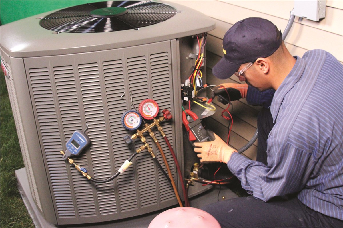 HVAC technician testing an outdoor air conditioning unit in Prescott Valley